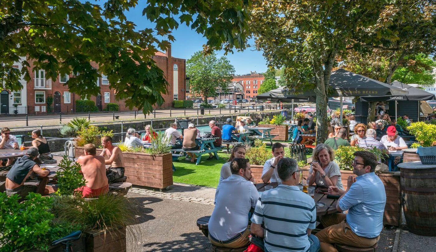 The Ostrich harbourside pub with large terrace and outdoor bar on a sunny day in Bristol
